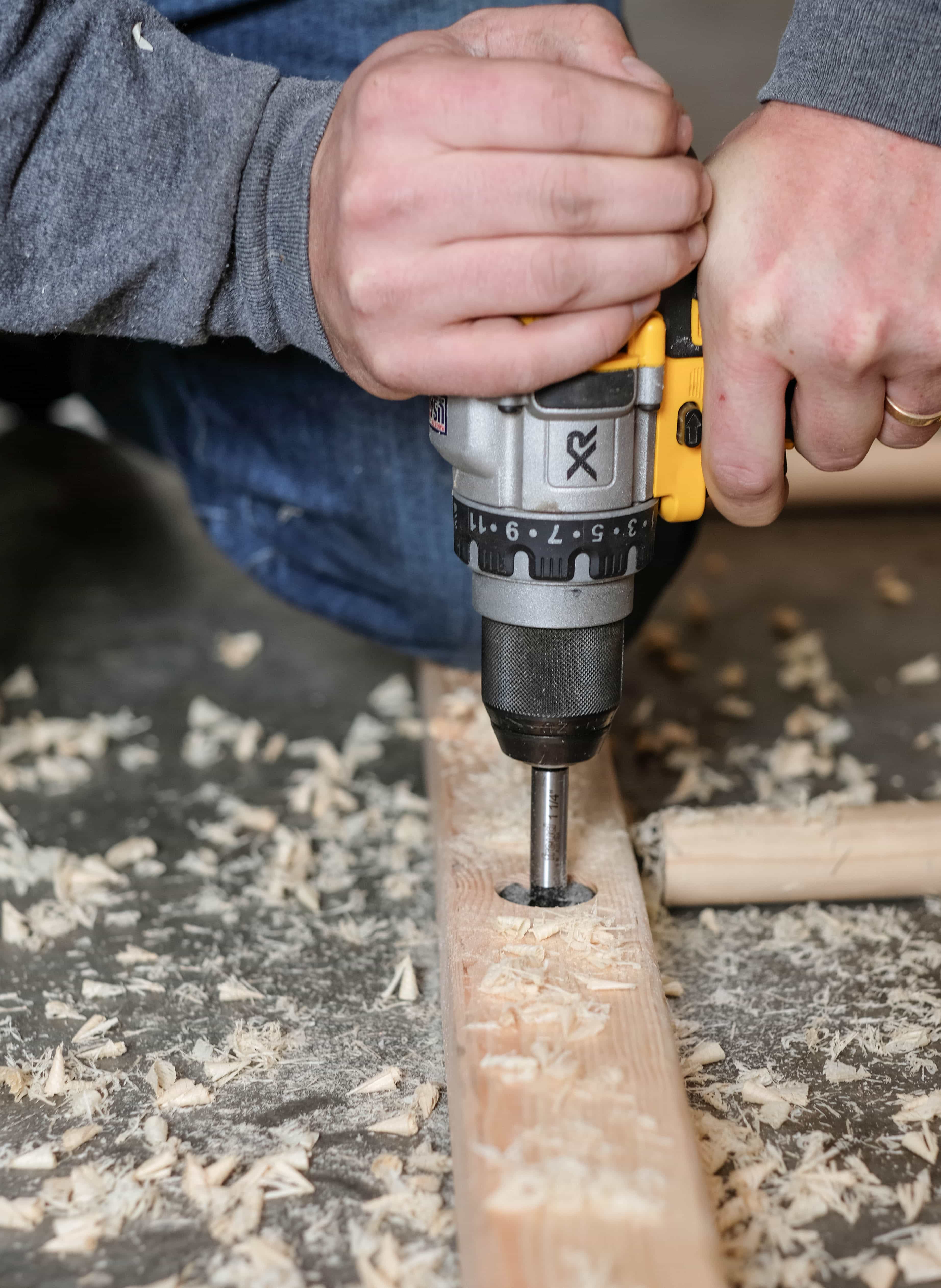 Drilling a hole in a board to build a blanket ladder