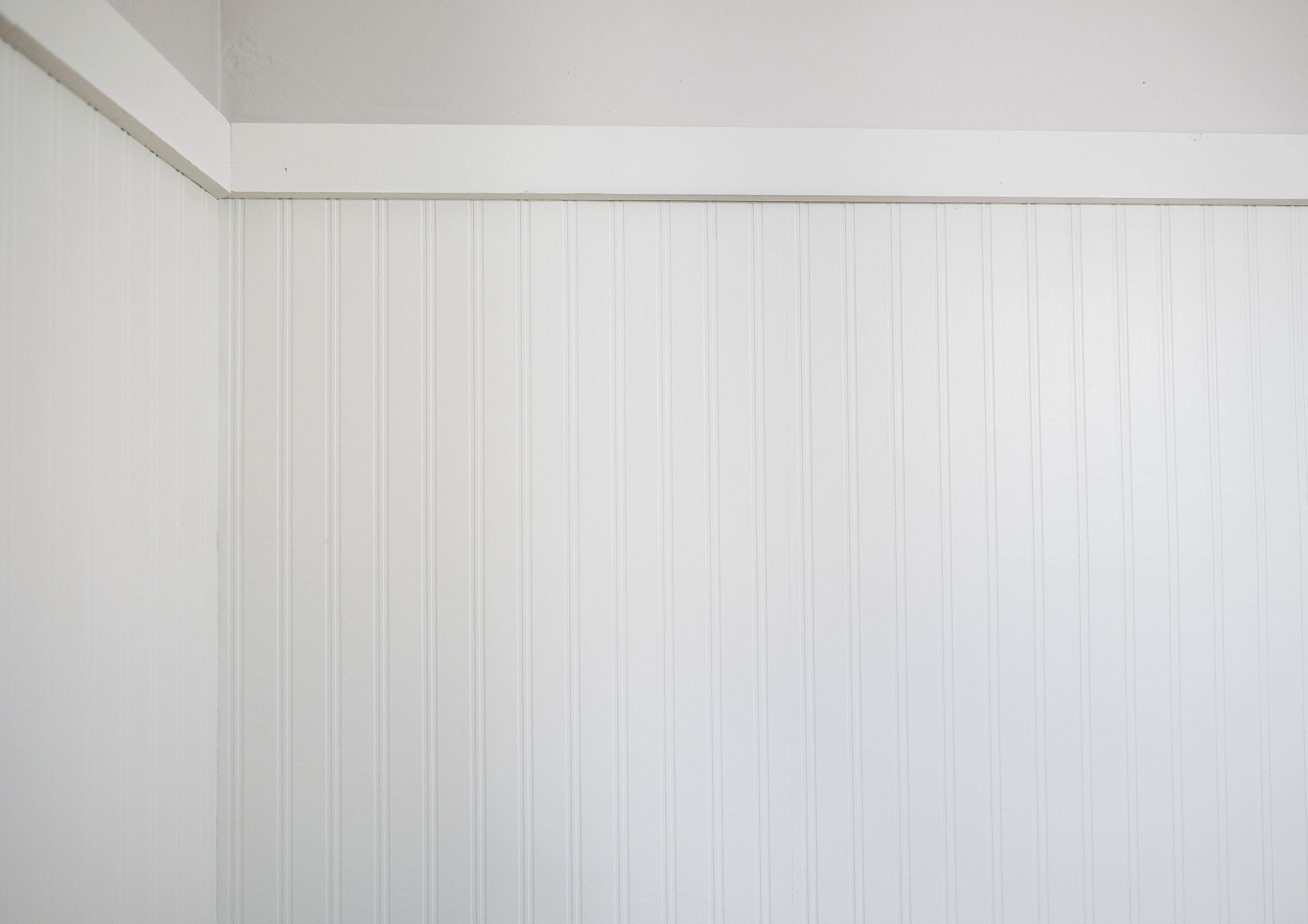 White beadboard wallpaper against light grey wall