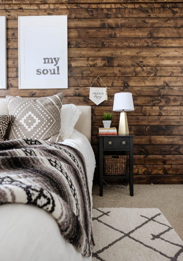 Wood accent wall in a decorated master bedroom 