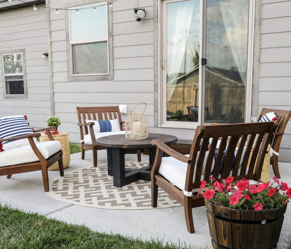 patio makeover with four chairs around a rustic coffee table