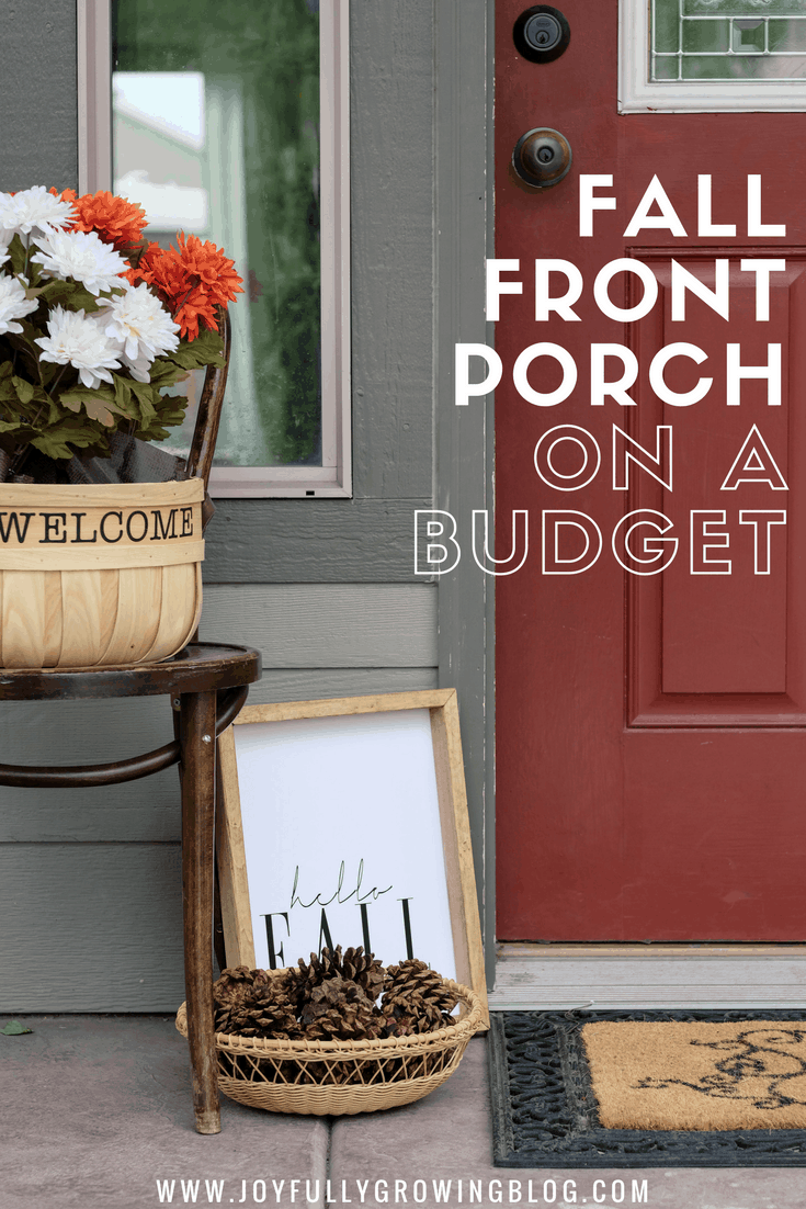 front porch decorated for fall with pinecones and flowers 