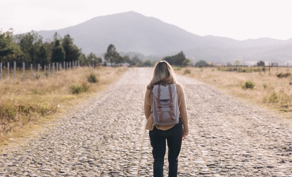 woman walks along road reading about 20 Clever Gift Ideas for Outdoor Enthusiasts