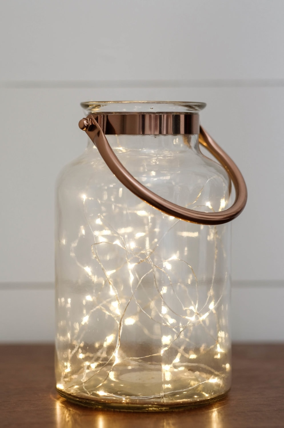 Christmas decor idea using a lantern filled with twinkle lights