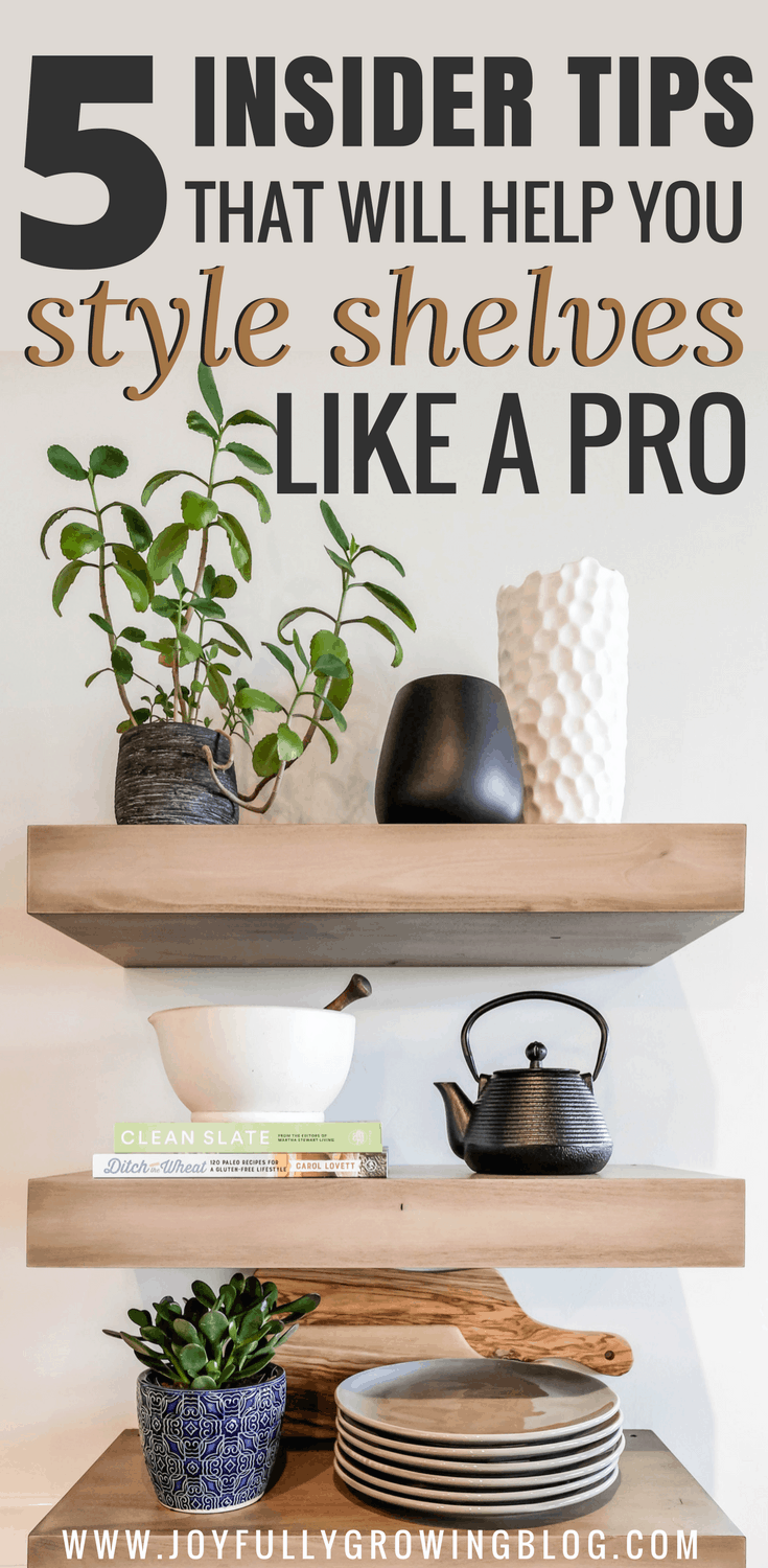 kitchen shelves decorated with plants, tableware, books and vases