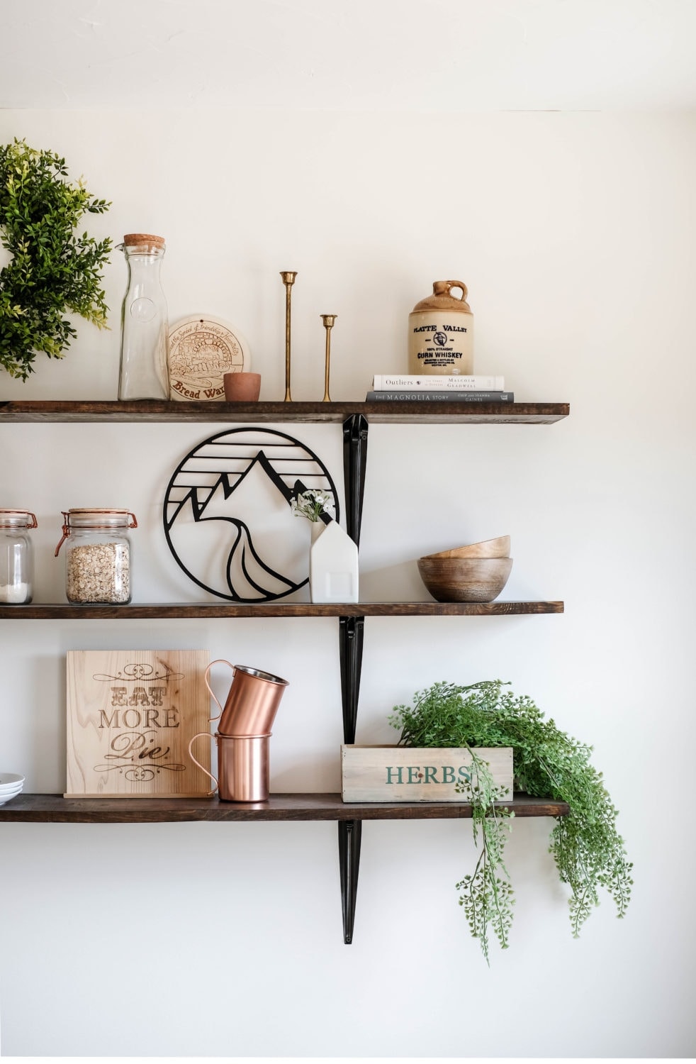 dining room shelves decorated with herbs, cups and bowls