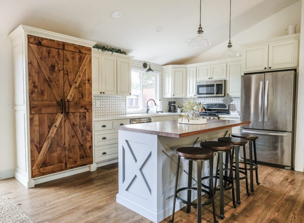 farmhouse kitchen on a budget with white cabinets and blue kitchen island