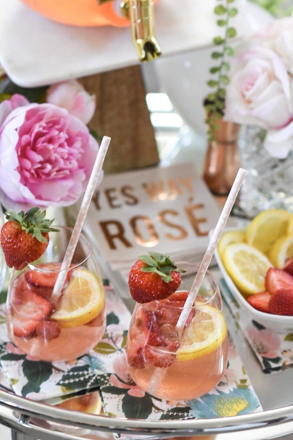 Stemless wine glass with strawberry lemonade sangria and straw inside