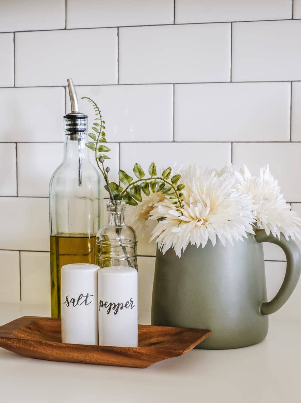 salt and pepper shakers with olive oil dispenser and flowers 