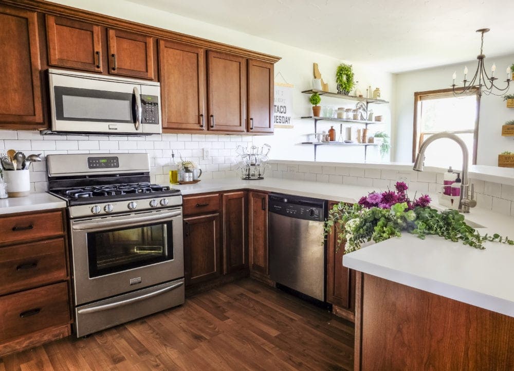 kitchen remodel after picture with fresh flowers decorating the farmhouse sink