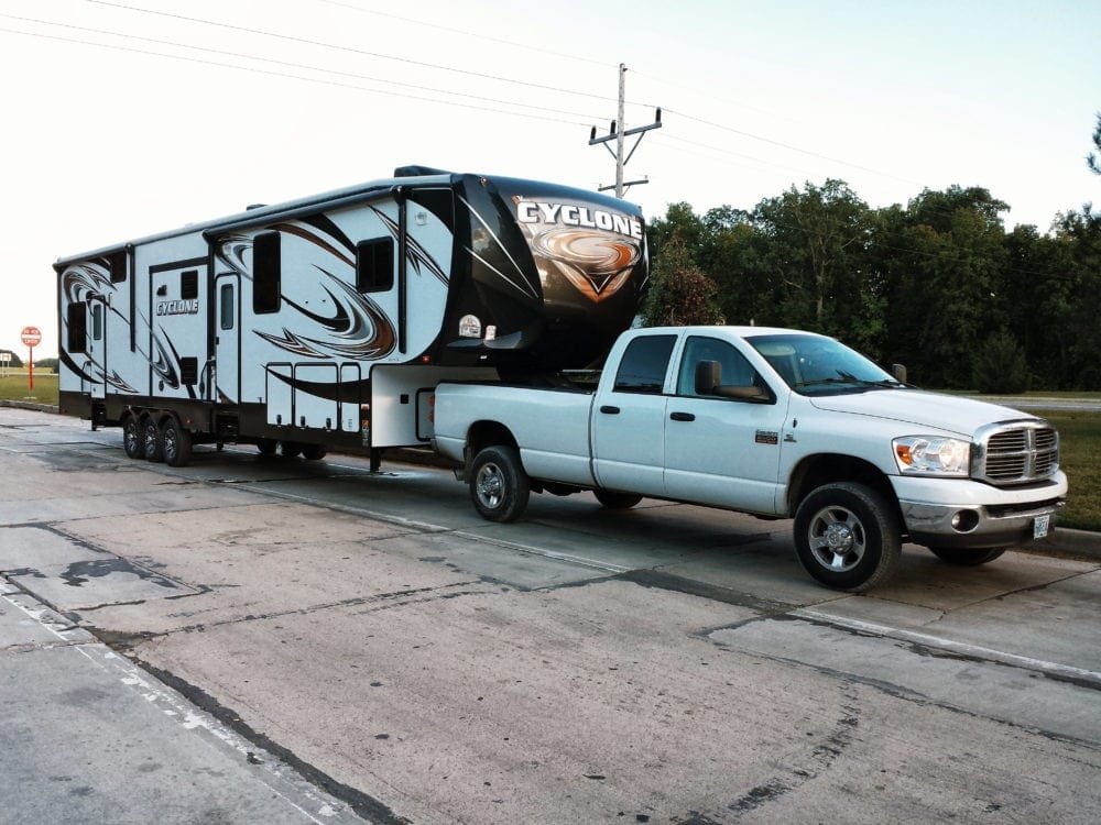 Fifth wheel behind a white truck ready for full time RV life