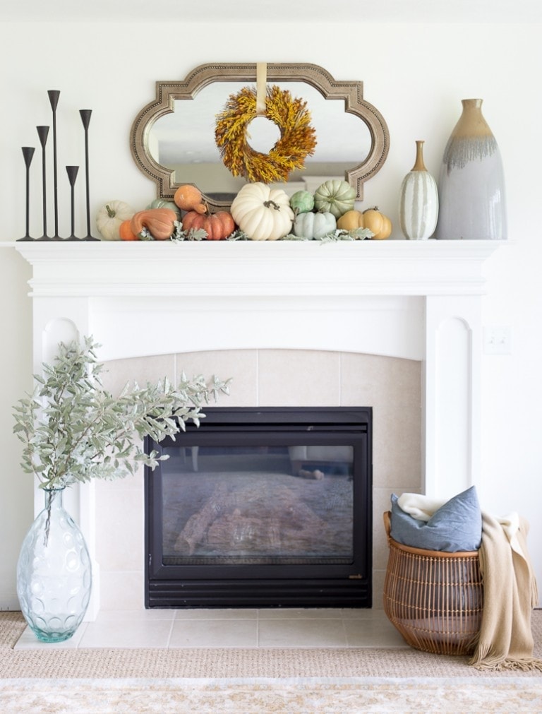 Fall mantel ideas using small pumpkins, black candle sticks and a mirror with wreath in front