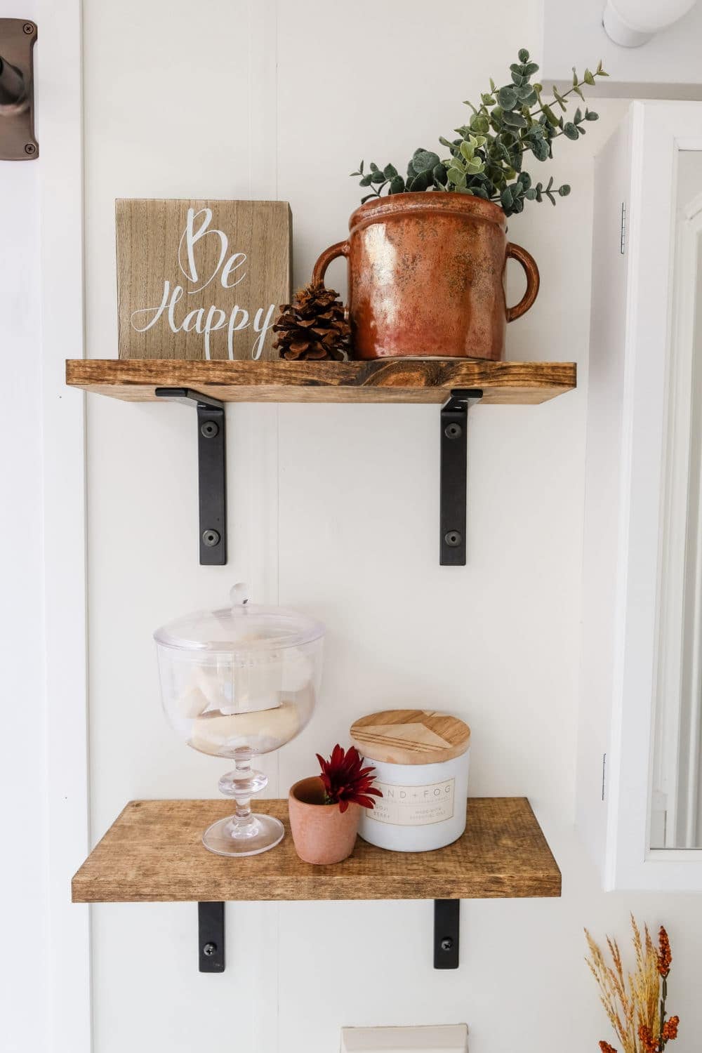 RV bathroom remodel with two open shelves styled with decor