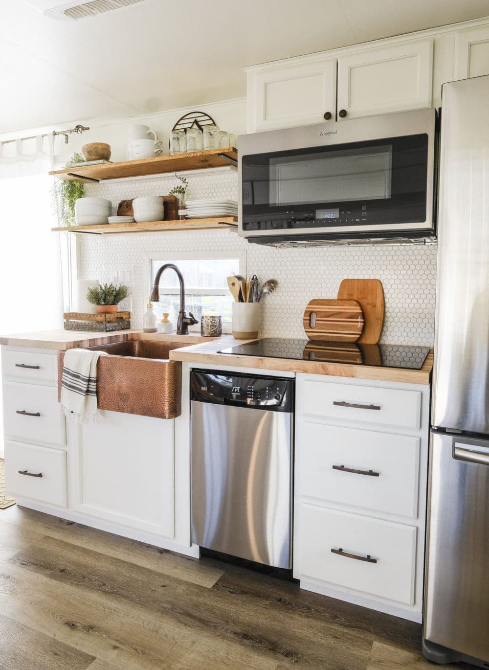 RV kitchen remodel with white cabinets and wood look flooring