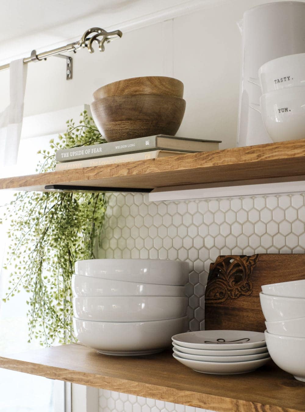 Open shelving with stacked bowls and cascading greenery