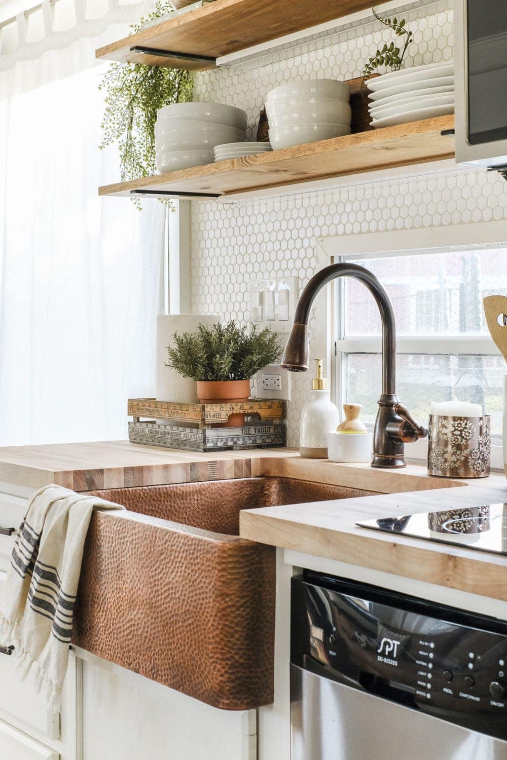 RV kitchen with a copper sink and butcher block counter tops