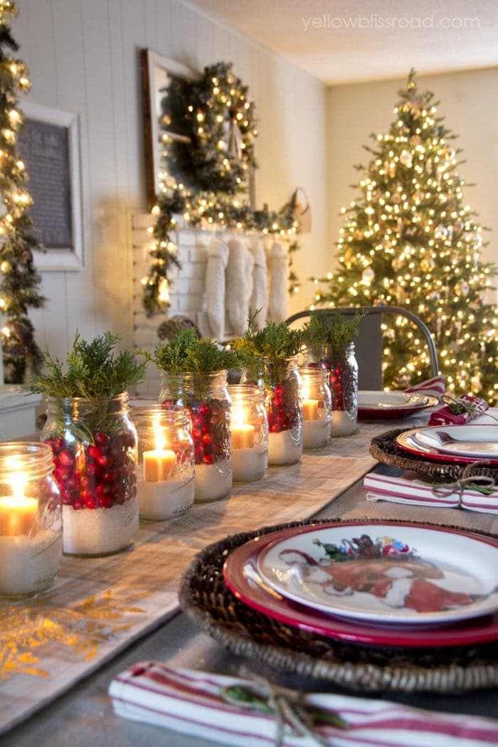 Christmas table centerpiece using mason jars, cranberries, and candles