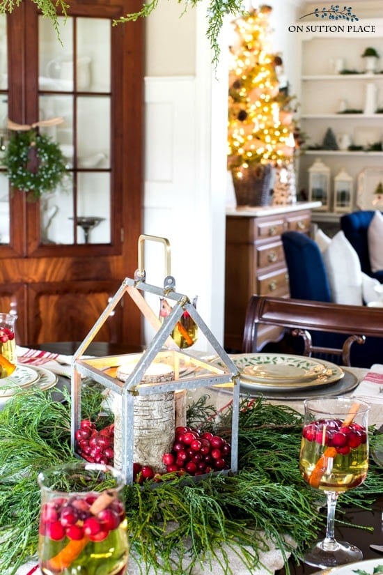 Christmas table centerpieces using a galvanized lantern, birch candles and cranberries