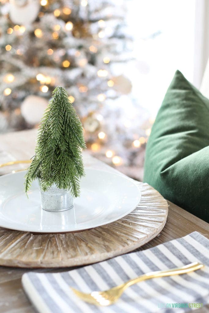 Mini artifiical tree in the center of a plate for a simple Christmas table setting ideas