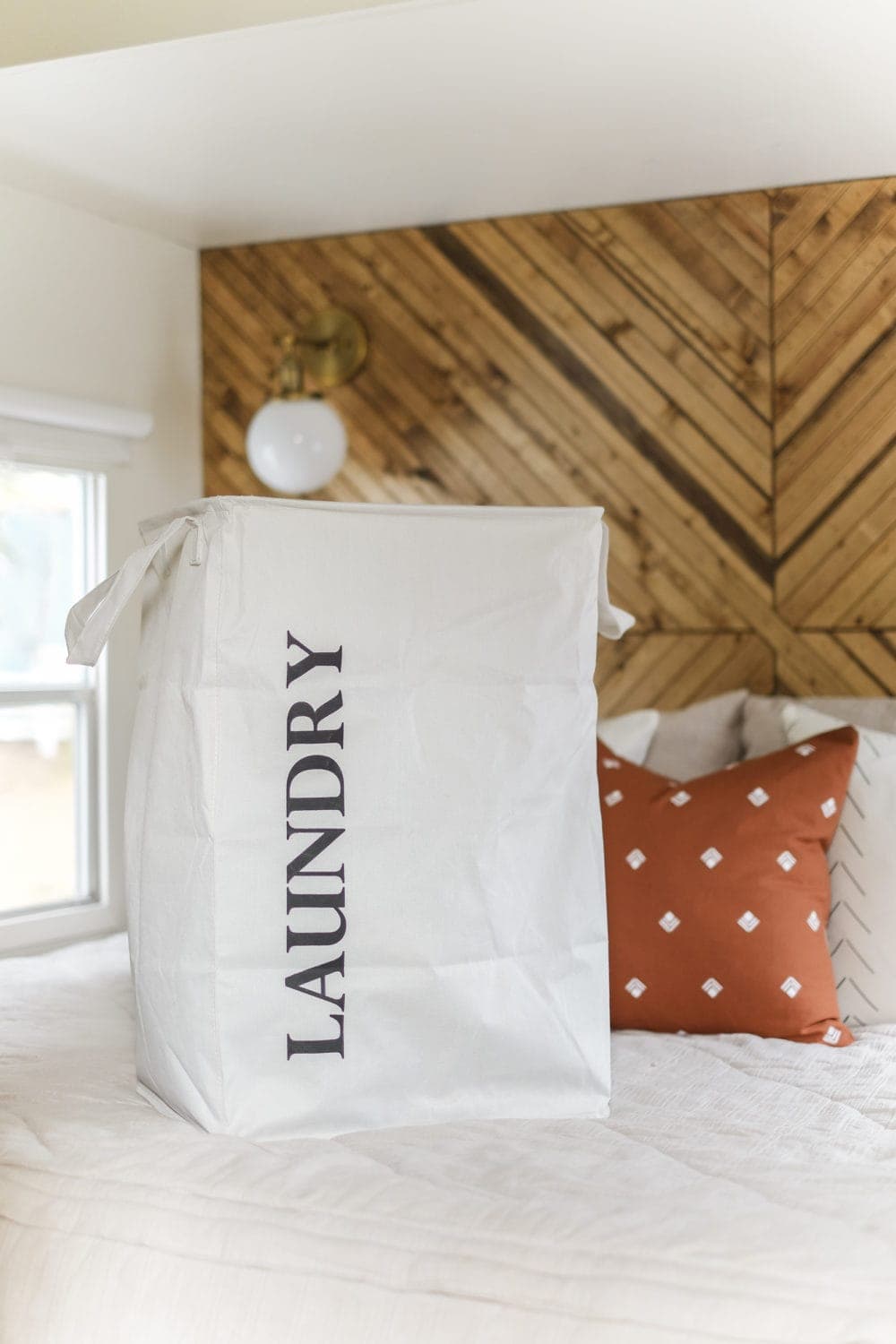 Laundty tote sitting on top of bed in an RV