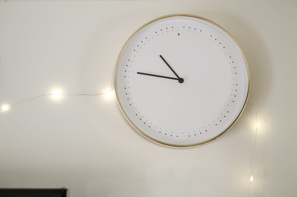 Wall clock with twinkle lights around it