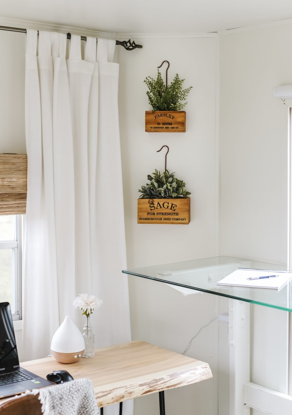 Wood herb planter boxes hung on the wall above home office desktop