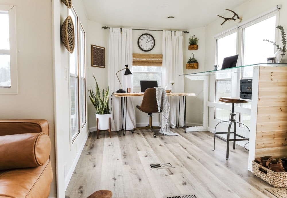 Home office inspiration with white walls, wood floors and two desk areas