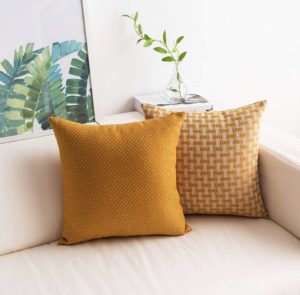 textured mustard yellow throw pillows set of 2 styled in a coastal style decor setting