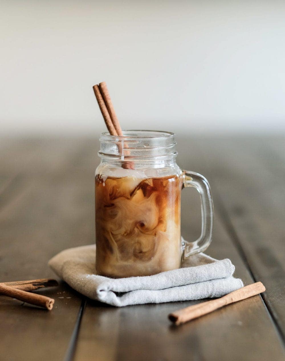 cold brew coffee in a mason jar with a cinnamon stick 