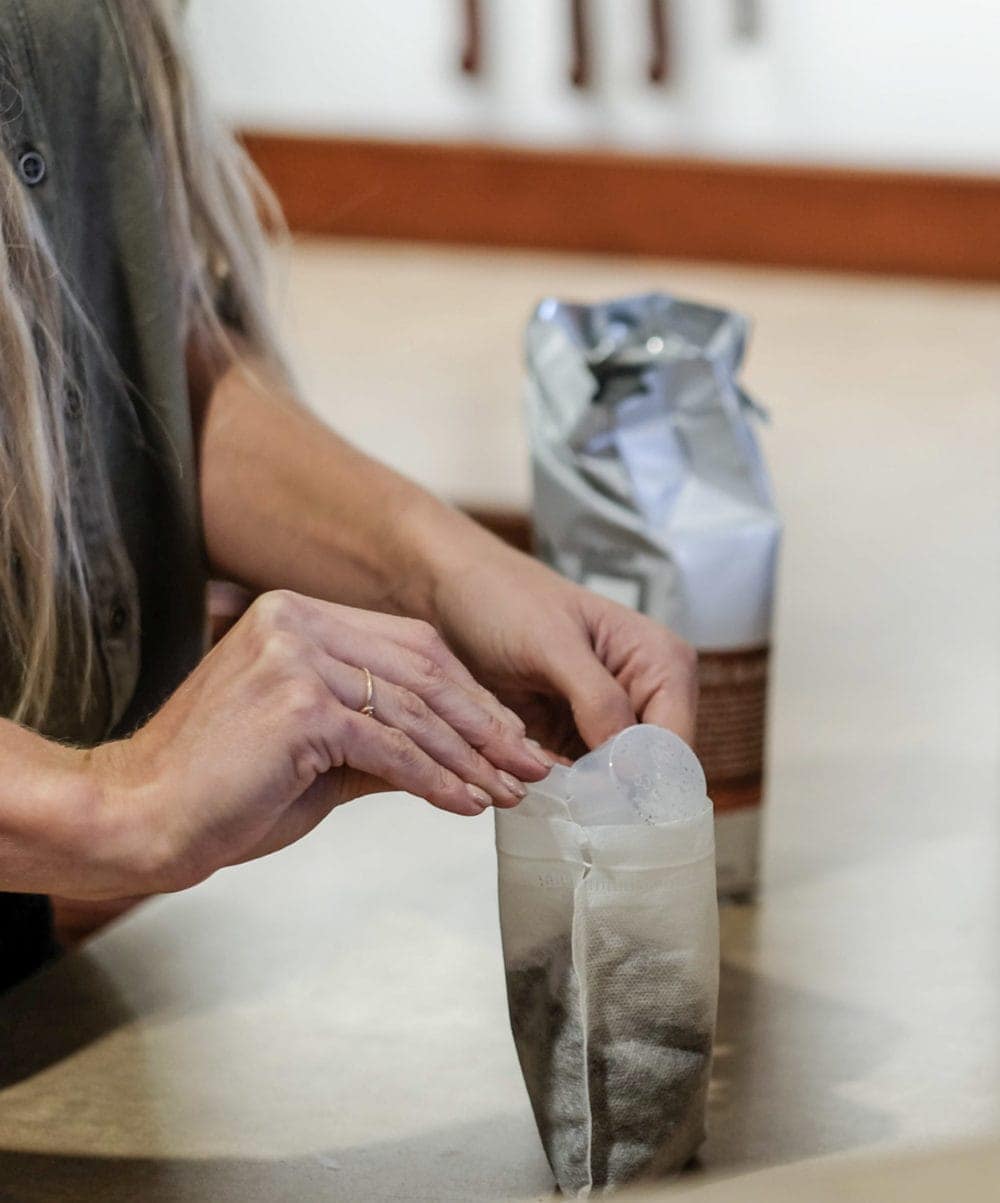 pouring coffee grinds into cold brew coffee filter bag