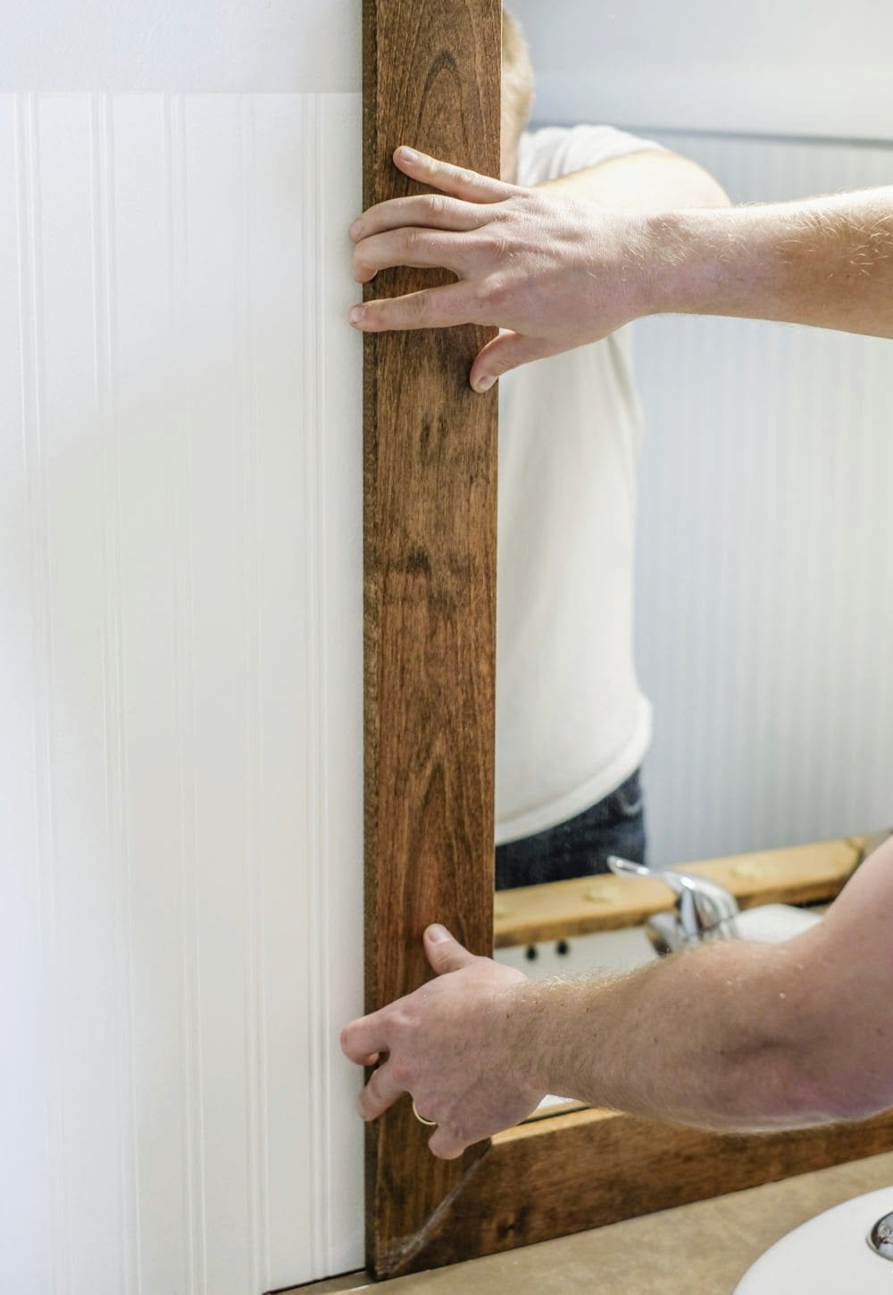 installing a frame around a bathroom mirror