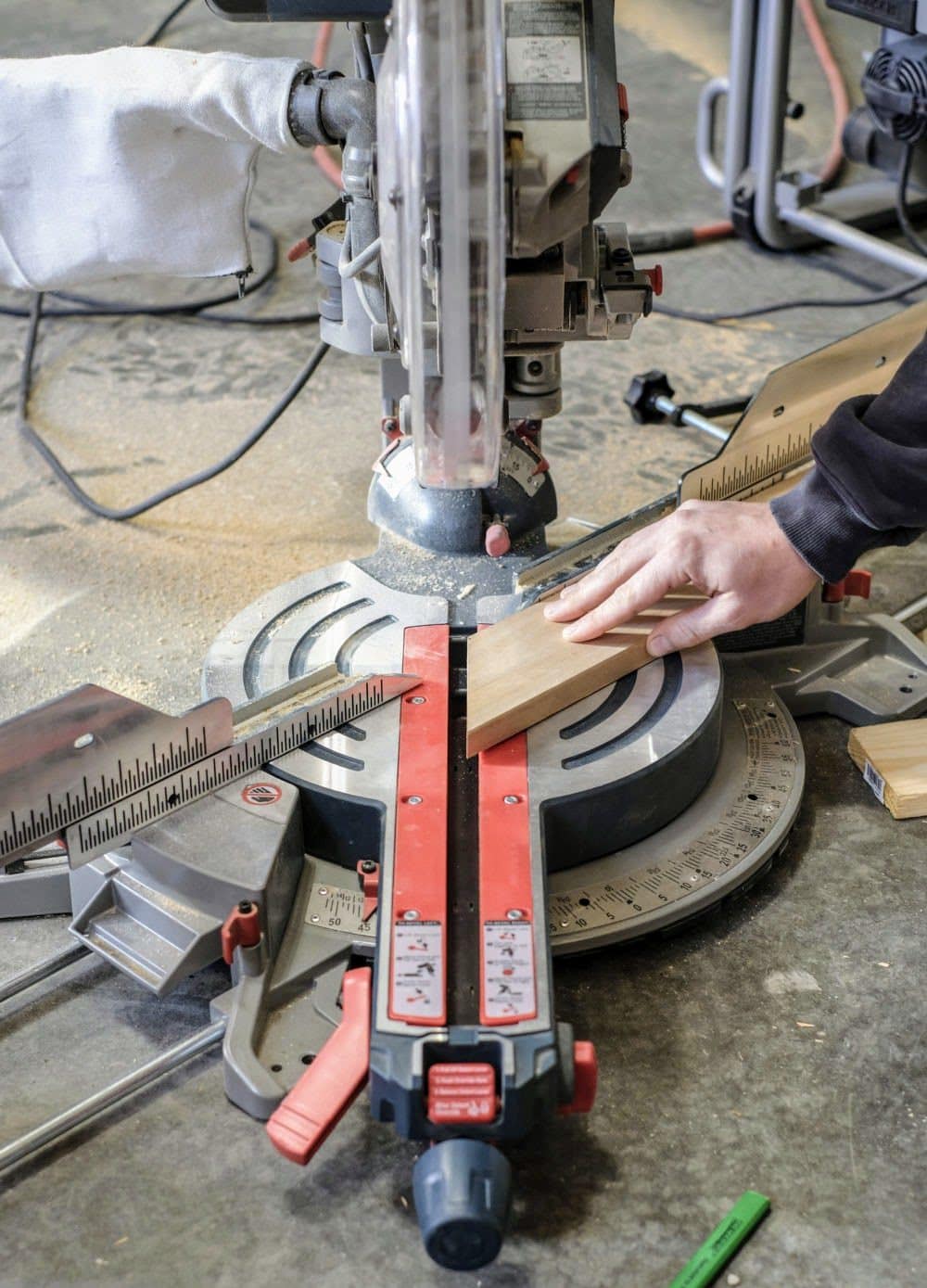 cutting a board with a miter saw at a 45 degree angle