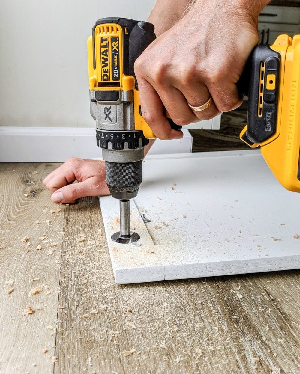  drilling a 35mm hole in a cabinet door to install a concealed hinge