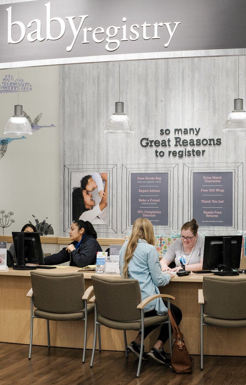 woman sitting at desk across from buy buy baby associate creating a baby registry