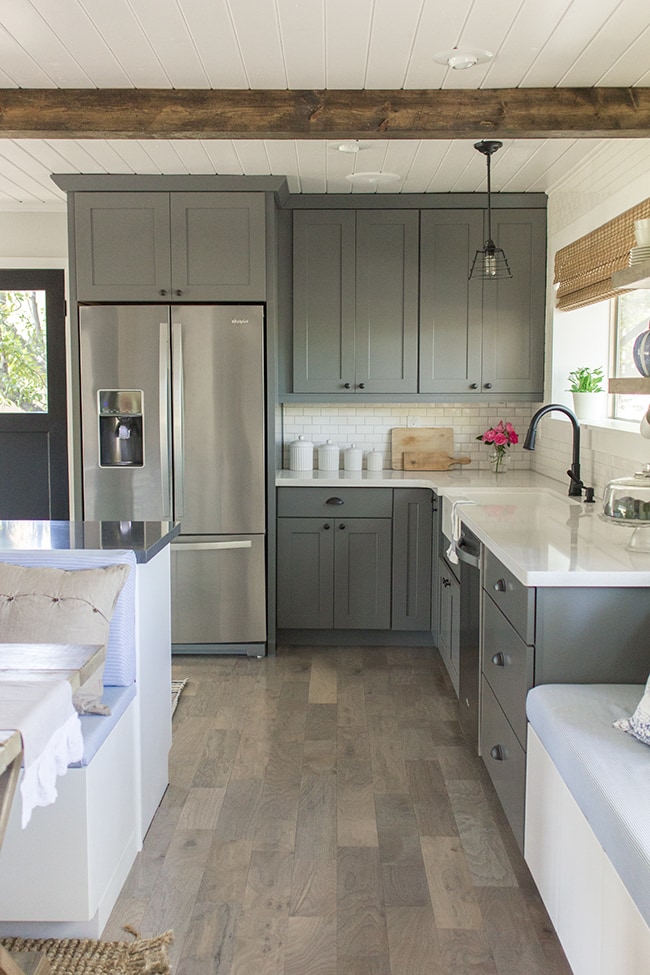 a kitchen with grey cabinets