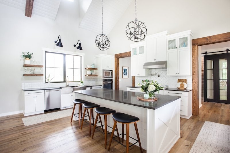 a kitchen with agreeable gray walls and white cabinets 