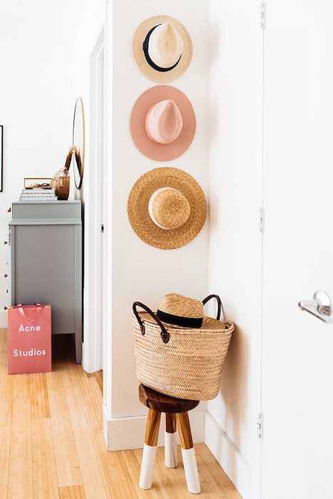 a wall with three hats hanging as decor