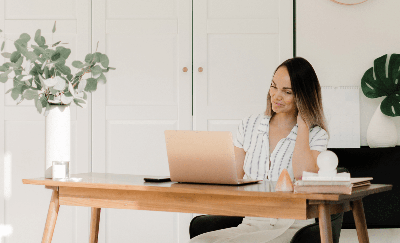 woman at desk thinking about Houseplant Decor Ideas