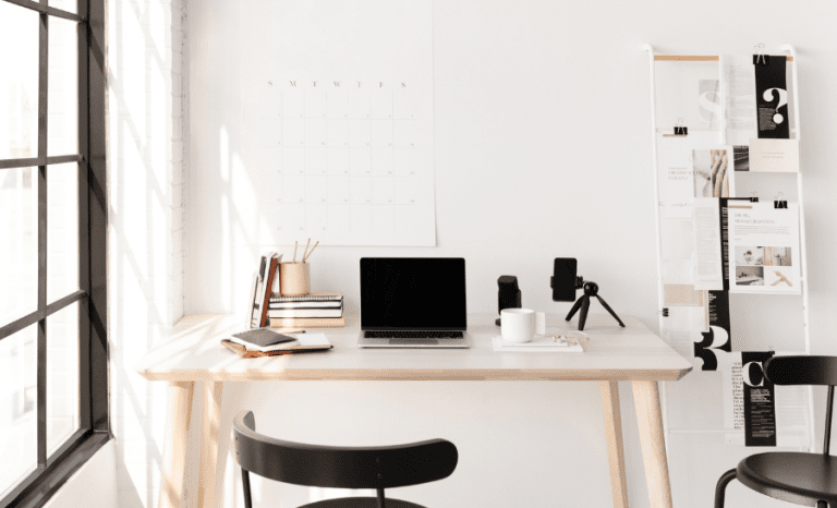Desk, laptop and ergonomic chair showing the best home office ideas for productivity