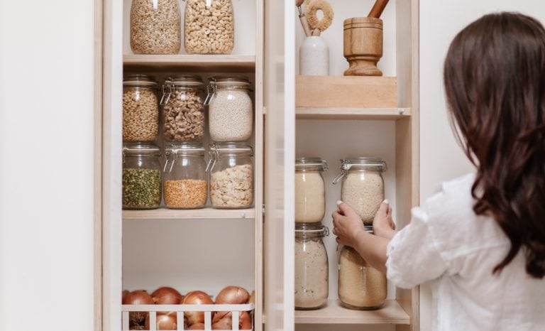 woman using storgae jars she bought at the Amazon Prime Early Access Sale