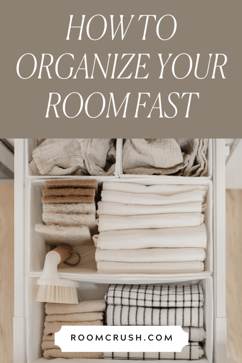 Open drawer full of organized towels showing how to organize your room