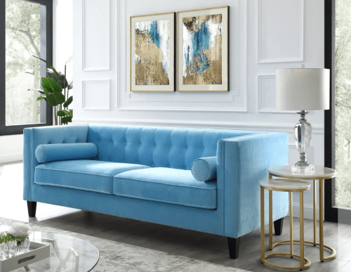 inspired home reviews lotte velvet sofa surrounded by a side table, lamp, and matching wall art