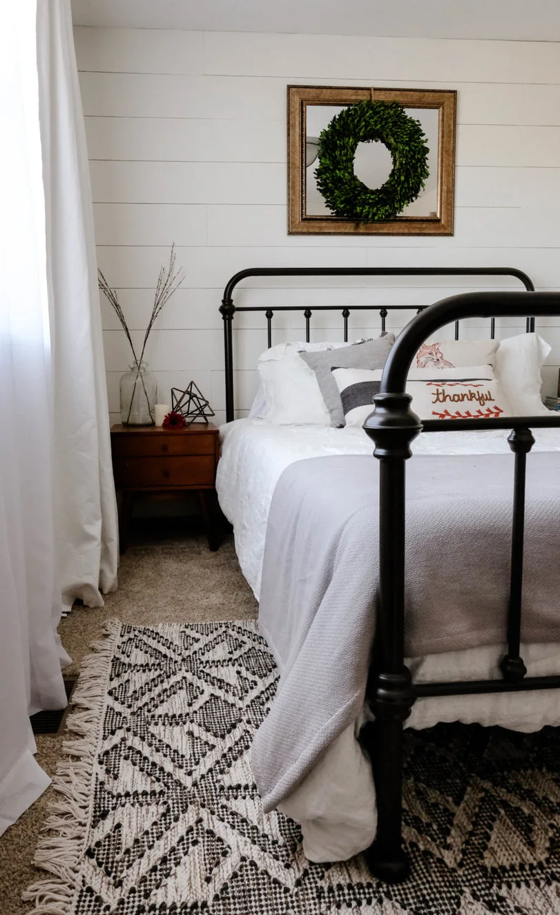 bedroom with sheer and blackout layered curtains