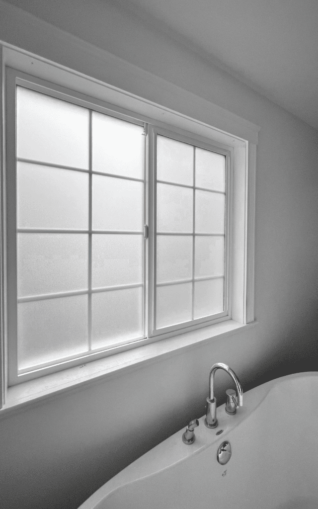 detail of the results of applying privacy window film to bathroom windows to make windows opaque and private