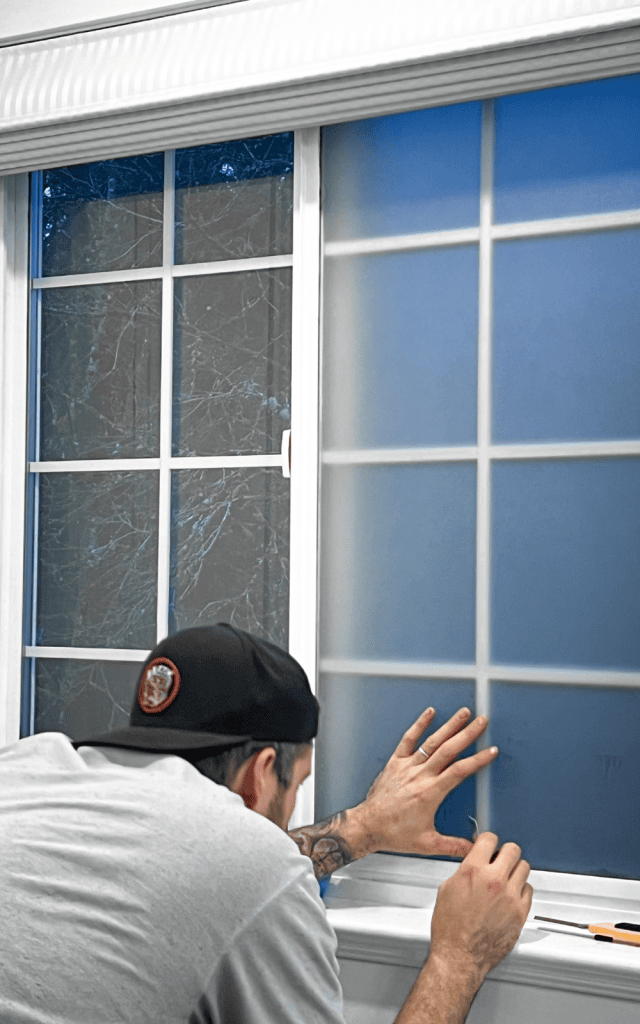 example of using a card to make the privacy window film smooth so there are no air bubbles