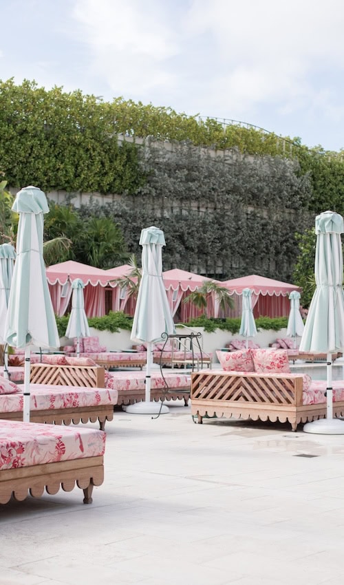 understanding the palm beach aesthetic - palm beach style rattan and pink patio funiture